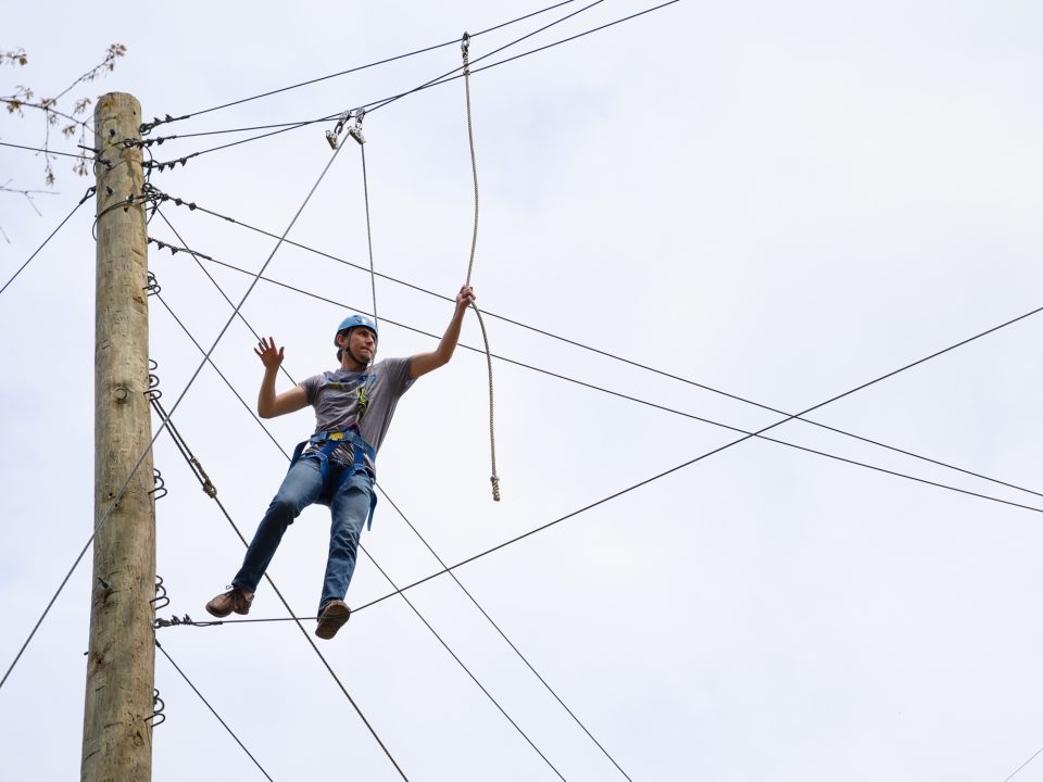 Visitor climbing our rope course